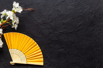 Asian background with hand fan and blossom branches