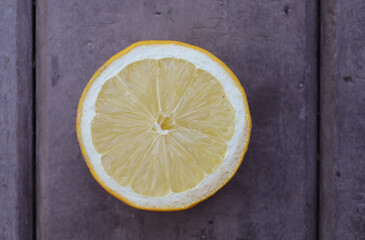 Bonn Germany June 2021 Cross-section of a lemon placed on a brown table in natural light
