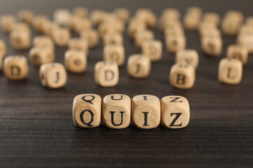 Cubes with word Quiz on wooden table. Space for text