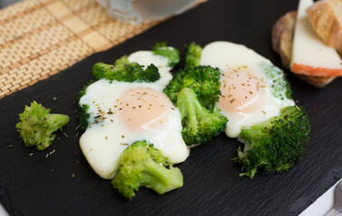 breakfast of crumpled eggs with broccoli