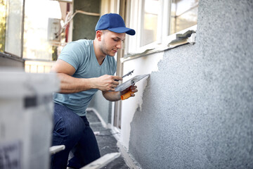 Man working on a house facade.