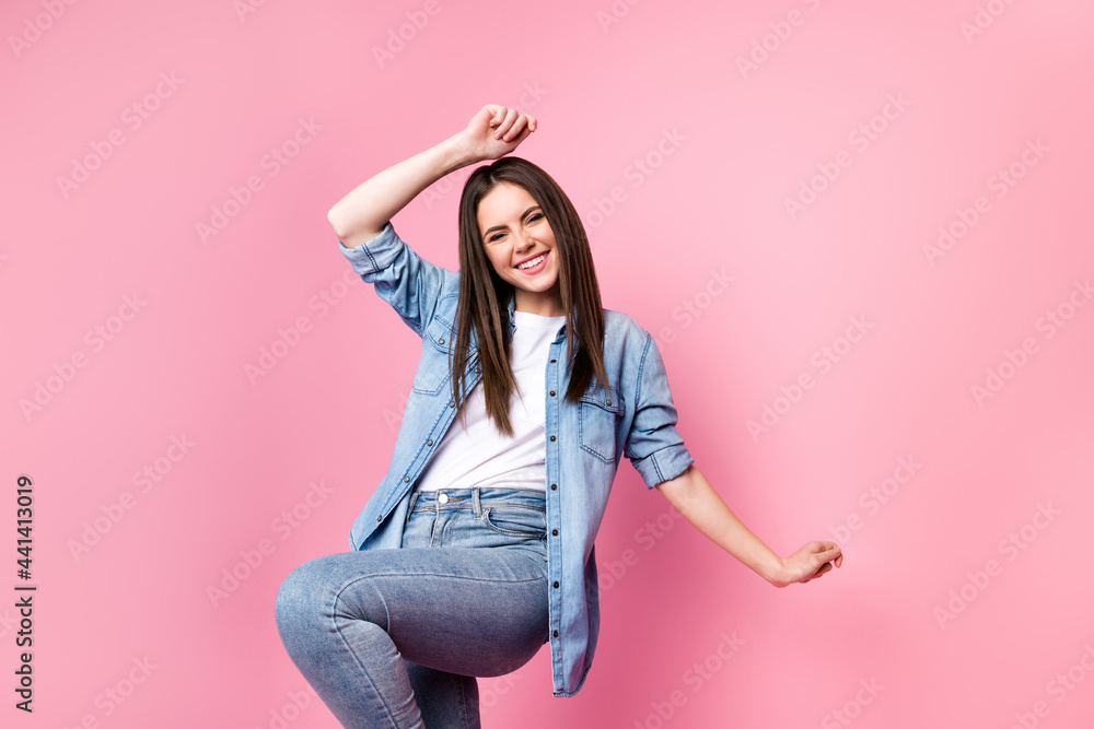 Wall mural Portrait of attractive carefree cheerful girl having fun dancing clubbing free time isolated over pink pastel color background