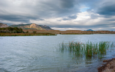 Beautiful Crimean landscape. Lake and mountains in the background with a beautiful evening sky.