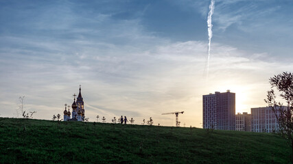Church of the saints and God's builders at sunrise against the backdrop of a clear sky and withered...