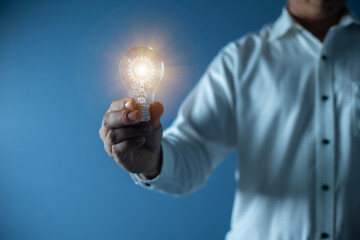 hand businessman holding light bulb, innovation and inspiration concept