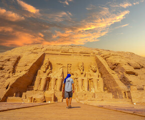 A young man walking towards the Abu Simbel Temple in southern Egypt in Nubia next to Lake Nasser....