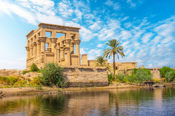 Fototapeta na wymiar The beautiful temple of Philae and the Greco-Roman buildings seen from the Nile river, a temple dedicated to Isis, goddess of love. Aswan. Egyptian