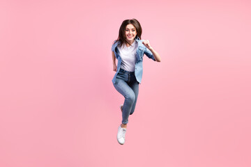 Fototapeta na wymiar Full length body size view of lovely cheerful girl jumping running fast good mood isolated over pink pastel color background