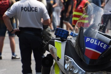 Close-up of a police motorbike with a policeman