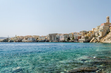 Famous Bay and Picturesque Neighborhood in Syros Island, Greece. Beautiful Scenic with Waterfront Buildings on a Sunny Day. Blue Sea and Sky