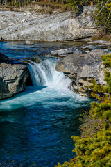 Fast flowing water rushes over the falls. Elbow Falls Provincial Recreation Area, Alberta, Canada