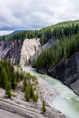Fototapeta na wymiar The Ram River flows through the mountain side. Ram Falls Provincial Park. Alberta, Canada