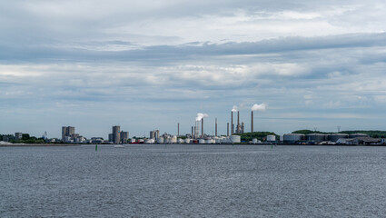 view of the Limfjord sound in Aalborg and the industrial distrit with factory chimneys