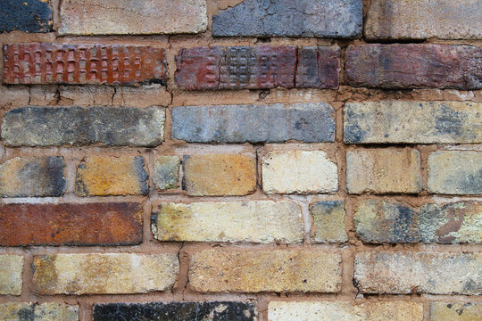 Old multi-colored brick wall. Close-up. Background. Texture.