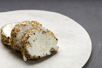 sliced chevre cheese on the table under the cheese paper circle
