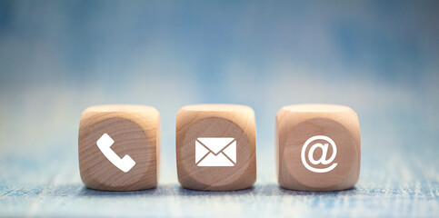 contact us icon (phone, email, mail ) on wood cube, customer service and support for self...