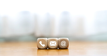 contact us icon (phone, email, mail ) on wood cube, customer service and support for self...