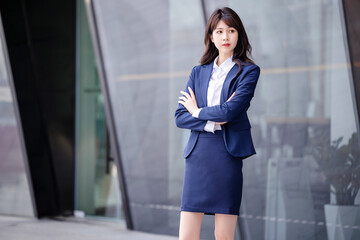 Beautiful Asian woman outdoors, wearing a suit