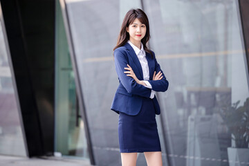 Beautiful Asian woman outdoors, wearing a suit