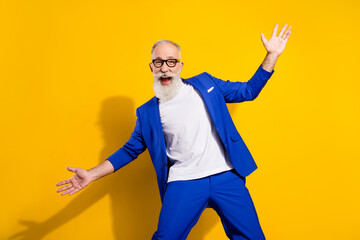 Photo of funny grey beard old man wear spectacles blue jacket isolated on vivid yellow color...