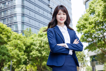 Beautiful Asian woman outdoors, wearing a suit