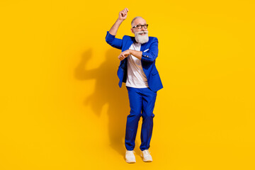 Full length body size view of nice attractive imposing cheerful man dancing having fun isolated over bright yellow color background - obrazy, fototapety, plakaty