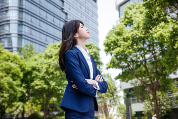 Beautiful Asian woman outdoors, wearing a suit