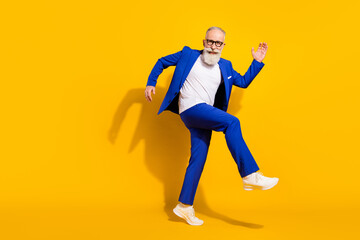Full size photo of young happy good mood cheerful businessman dancing having fun isolated on yellow...