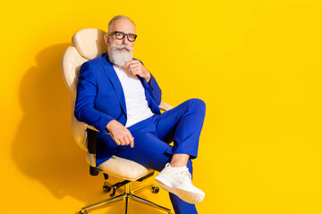 Photo portrait of boss thoughtful sitting in white chair in office isolated bright yellow color...