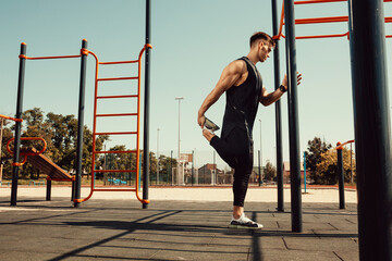 athletic guy warms up before classes on the horizontal bar