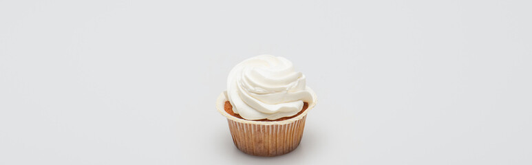 baked tasty cupcake with icing on top on white, banner