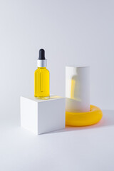 White cube podium with bottle of essential oil on it