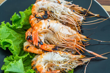 Grilled river prawn on dish. Flame grilled prawns on plates. Local food in Thailand. Regional Food Backgrounds