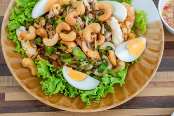 Winged bean spicy sour salad with boil egg and cashew nut in Thailand it is called Yam Tua Phuu. Local food in Thailand . Regional Food Backgrounds