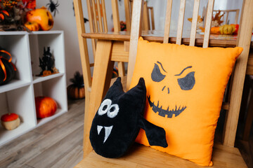 Halloween style pillows placed on wooden chair