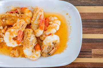 Fried Shrimp with Garlic and Pepper on white dish. Local food in Thailand. Regional Food Backgrounds