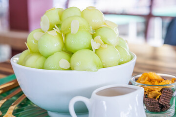 Ice watermelon Bingsu with sliced almond. Bingsu or Bingsu is a Korean shaved ice dessert with sweet toppings such as ice cream vanilla, whipped cream and sweetened condensed milk. Regional Food Backg