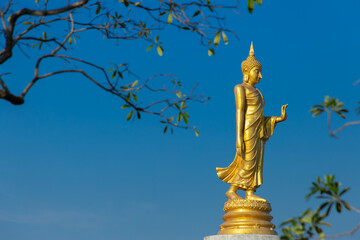 The standing buddha with blue sky in Thailand.