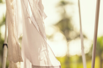 Closeup hanging laundry on balcony on the drying rack at sunset sunshine