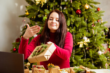 Woman demonstrates packaging of ecological Christmas gifts online