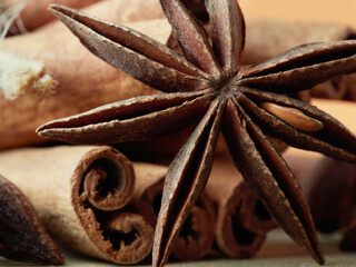 Elegant spice view - cinnamon and star anise on a black wooden background
