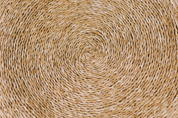Background, texture of wicker yellow vine, straw, rattan in a circle. Photography, concept.