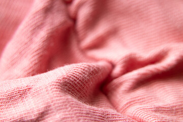 pink crumpled fabric as a background macro photo