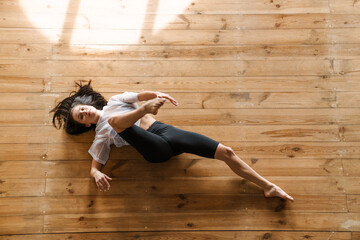 Young slim brunette fitness woman stretching