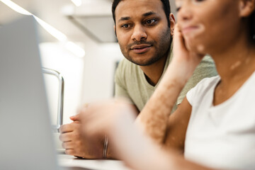 Mid aged multiethnic couple working together