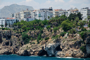 seaside with rocky coast and residential buildings