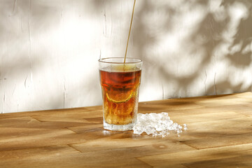 Fresh cold ice tea and wooden desk 