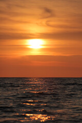 Fototapeta premium Evening sun over the tropical sea with waves