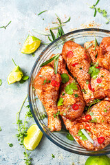Raw Chicken Drumsticks Legs Marinating in Herbs and Hot Spices for BBQ Grill