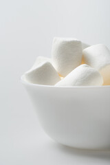 soft and chewy marshmallows in bowl on white
